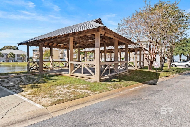 surrounding community featuring a water view and a lawn