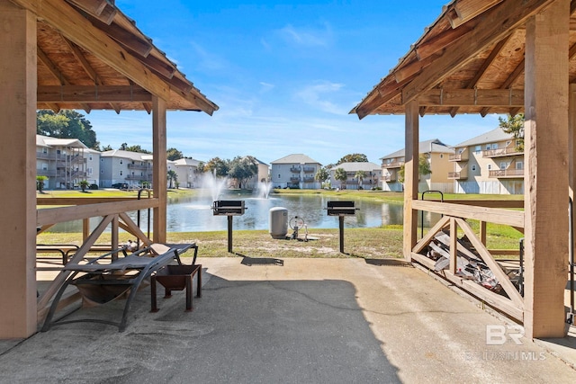 view of patio / terrace featuring a gazebo and a water view