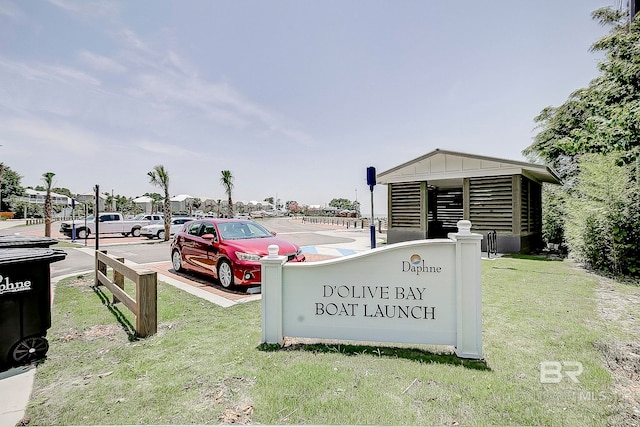 community sign featuring a lawn