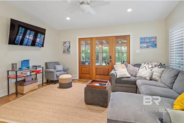 living room with french doors, light wood-type flooring, and ceiling fan