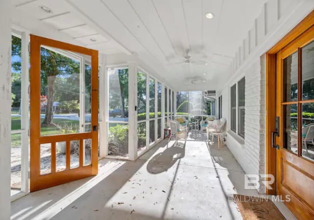 sunroom / solarium featuring ceiling fan