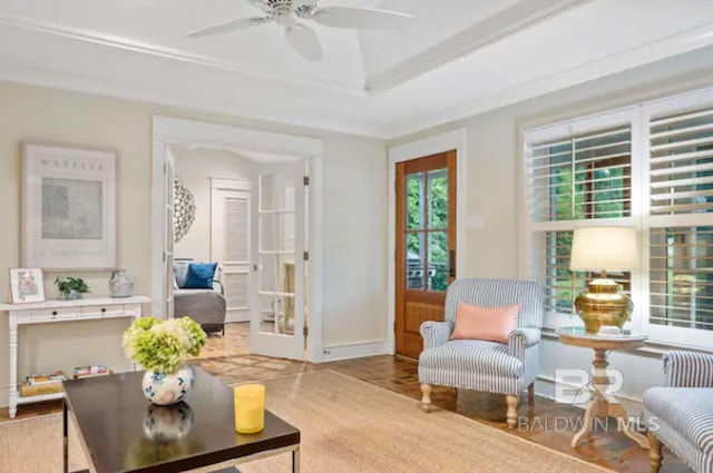 living area featuring hardwood / wood-style floors, ceiling fan, a tray ceiling, and french doors