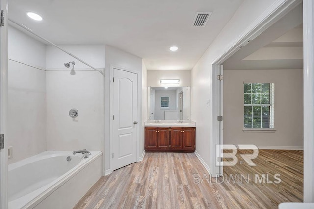 31246 Shambo Rd, Spanish Fort, AL 36527 - bathroom featuring wood finished floors, vanity,  shower combination, and recessed lighting