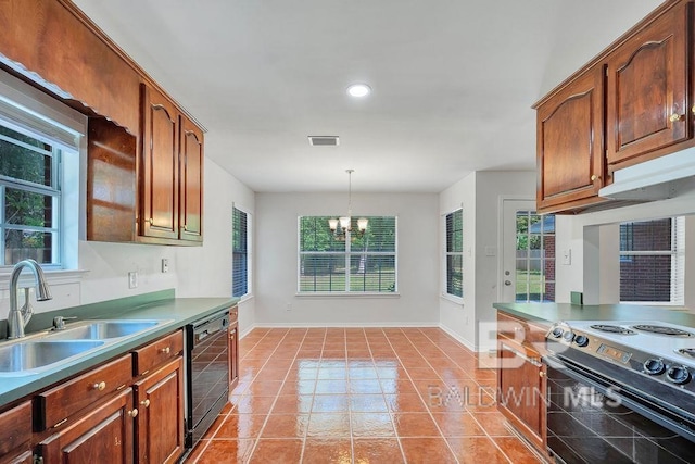 31246 Shambo Rd, Spanish Fort, AL 36527 - kitchen with a chandelier, black appliances, light tile patterned floors, hanging light fixtures, and recessed lighting