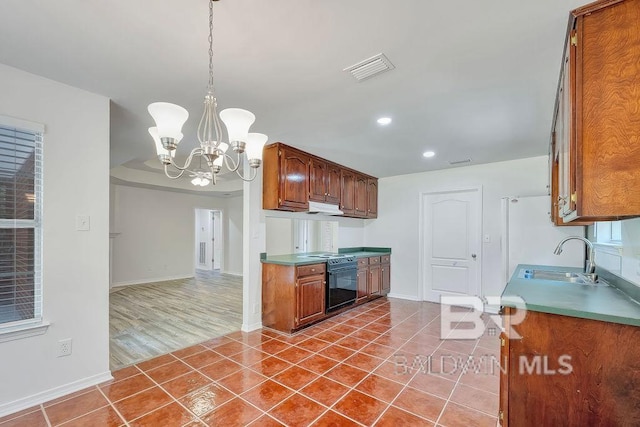 31246 Shambo Rd, Spanish Fort, AL 36527 - kitchen with a chandelier, wall oven, tile patterned floors, recessed lighting, and under cabinet range hood