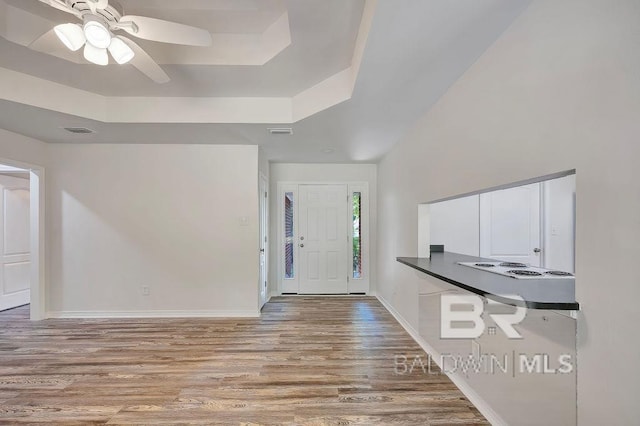 31246 Shambo Rd, Spanish Fort, AL 36527 - foyer entrance featuring wood finished floors, a ceiling fan, and a raised ceiling