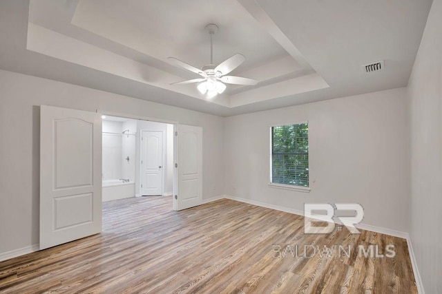 31246 Shambo Rd, Spanish Fort, AL 36527 - spare room featuring a raised ceiling, light wood-style floors, and ceiling fan