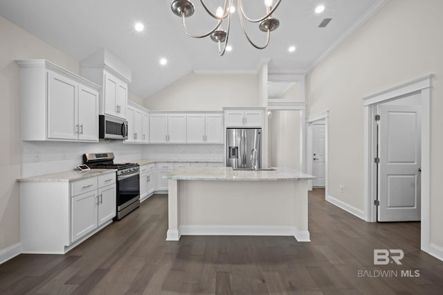kitchen with appliances with stainless steel finishes, backsplash, white cabinetry, and an island with sink