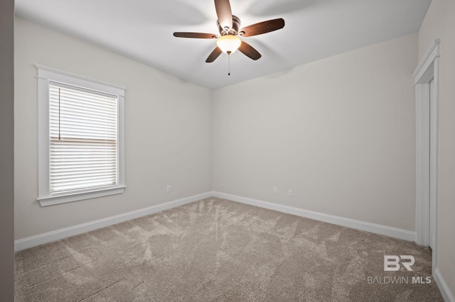 spare room featuring baseboards, carpet, and ceiling fan