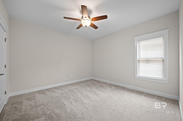 unfurnished room featuring baseboards, ceiling fan, and carpet