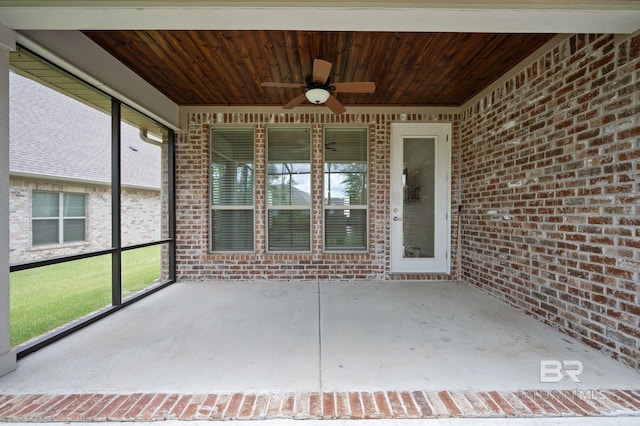 unfurnished sunroom with a ceiling fan