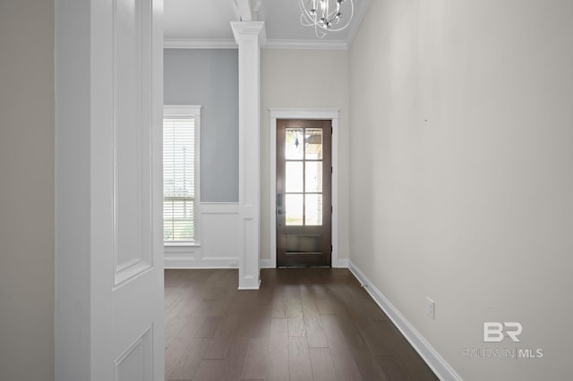 doorway to outside with a wainscoted wall, ornamental molding, dark wood-style flooring, and a chandelier