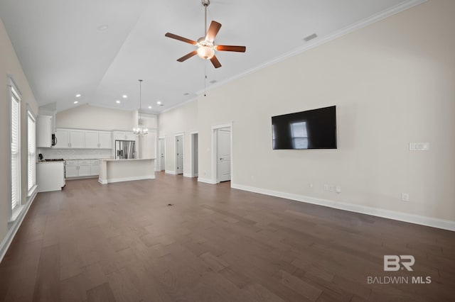 unfurnished living room featuring baseboards, ceiling fan with notable chandelier, recessed lighting, and dark wood-type flooring