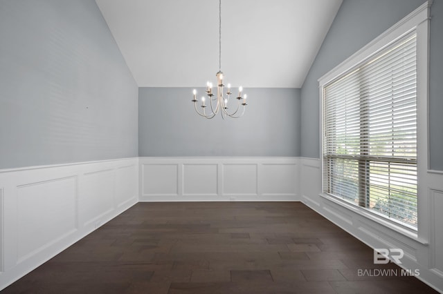 unfurnished dining area with an inviting chandelier, dark wood-style flooring, lofted ceiling, and a wainscoted wall