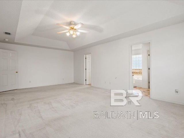 11554 Braga Dr, Daphne, AL 36526 - spare room with a raised ceiling, ceiling fan, light carpet, and baseboards