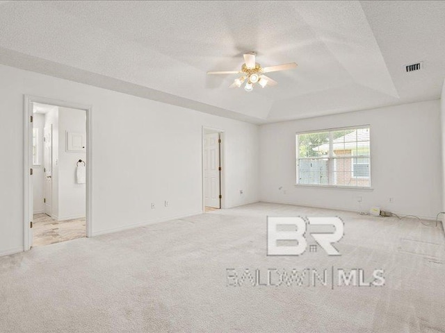 11554 Braga Dr, Daphne, AL 36526 - carpeted empty room with ceiling fan, a raised ceiling, a textured ceiling, and baseboards