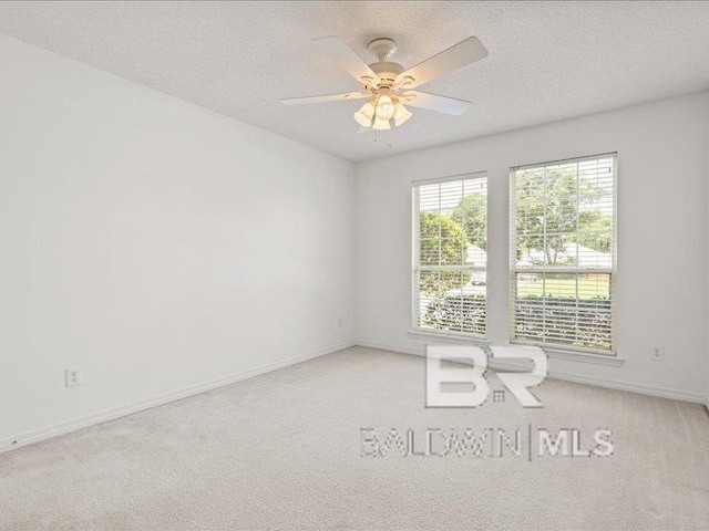 11554 Braga Dr, Daphne, AL 36526 - carpeted spare room featuring a ceiling fan, baseboards, and a textured ceiling