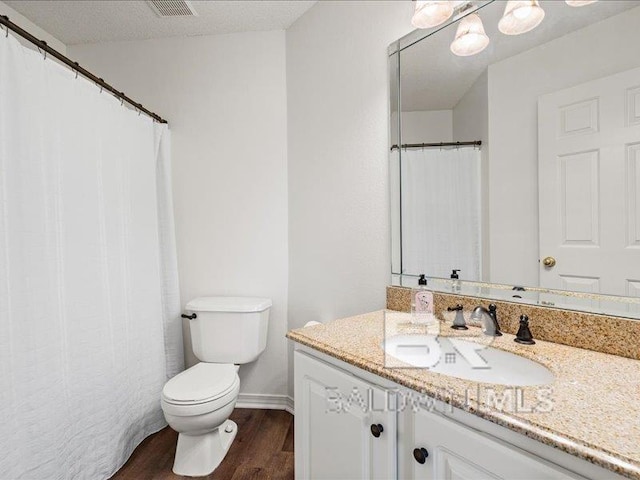 11554 Braga Dr, Daphne, AL 36526 - bathroom featuring wood finished floors, toilet, vanity, and baseboards