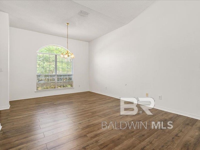 11554 Braga Dr, Daphne, AL 36526 - empty room featuring a chandelier, wood finished floors, and baseboards