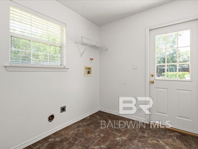 11554 Braga Dr, Daphne, AL 36526 - laundry room featuring hookup for a washing machine, electric dryer hookup, baseboards, and a textured ceiling
