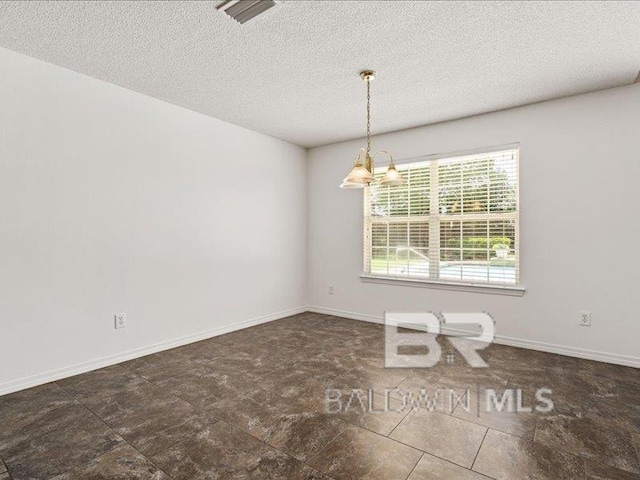 11554 Braga Dr, Daphne, AL 36526 - unfurnished dining area featuring a textured ceiling and baseboards