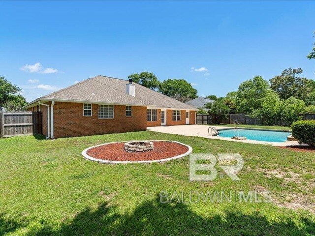 11554 Braga Dr, Daphne, AL 36526 - rear view of property with brick siding, an outdoor fire pit, and a patio
