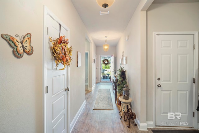 hallway with light hardwood / wood-style flooring