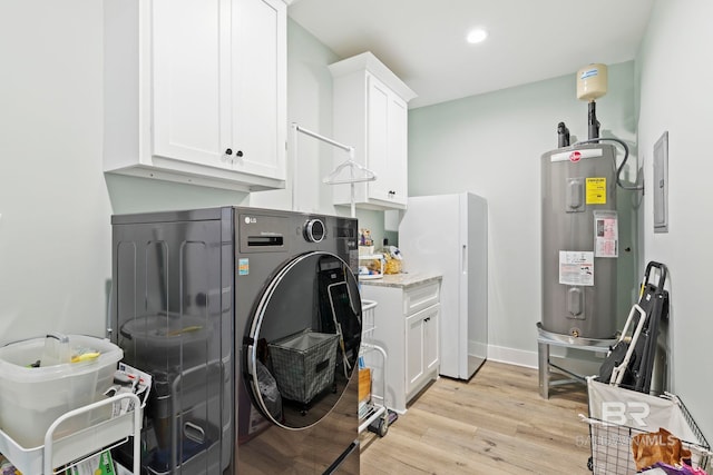 laundry room with cabinets, light hardwood / wood-style flooring, electric panel, independent washer and dryer, and water heater