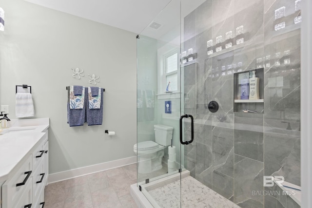 bathroom with walk in shower, vanity, and toilet