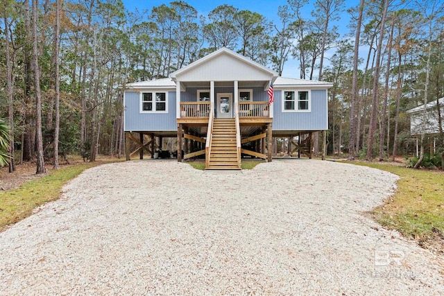 coastal home with a porch and a carport