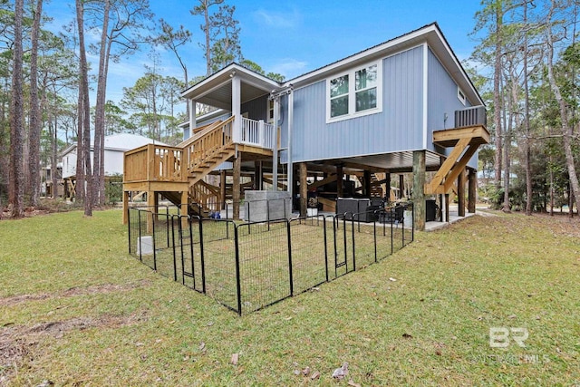 rear view of property with a yard