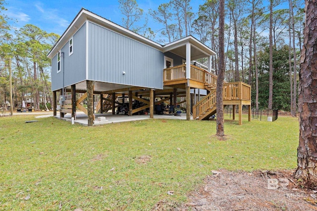 back of property with a deck and a lawn