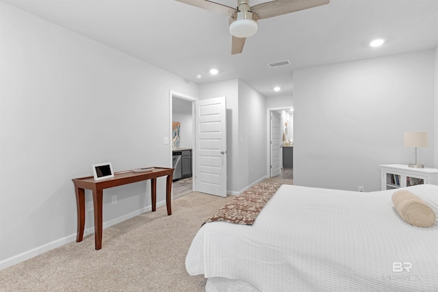 bedroom featuring ensuite bathroom, ceiling fan, and light colored carpet