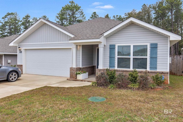 view of front of home featuring a front yard and a garage