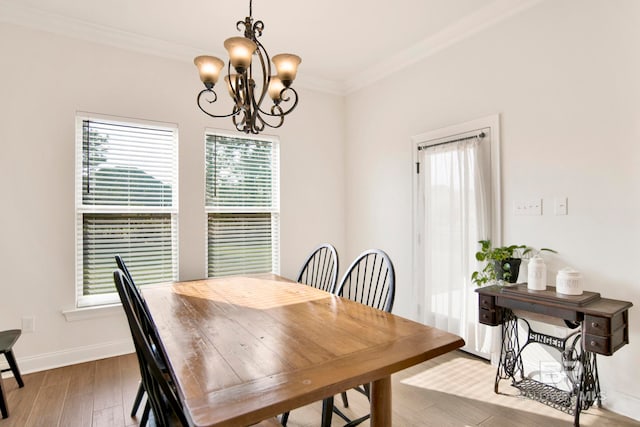 22258 Hibiscus Cir, Foley, AL 36535 - dining room featuring an inviting chandelier, baseboards, light wood-type flooring, and ornamental molding
