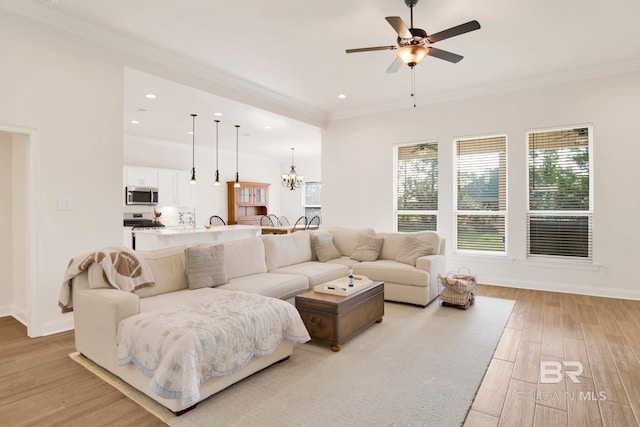 22258 Hibiscus Cir, Foley, AL 36535 - living area with baseboards, ceiling fan with notable chandelier, light wood-type flooring, and ornamental molding