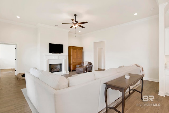 22258 Hibiscus Cir, Foley, AL 36535 - living area featuring wood finished floors, ceiling fan, and crown molding