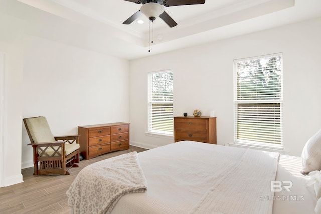 22258 Hibiscus Cir, Foley, AL 36535 - bedroom with light wood finished floors, baseboards, a tray ceiling, recessed lighting, and a ceiling fan
