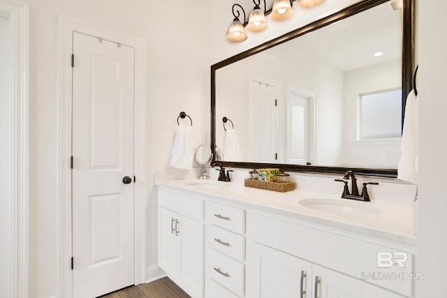 22258 Hibiscus Cir, Foley, AL 36535 - bathroom featuring a sink, wood finished floors, and double vanity