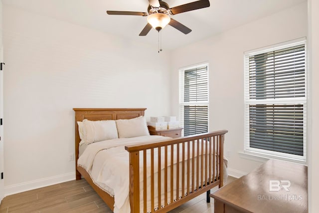 22258 Hibiscus Cir, Foley, AL 36535 - bedroom with baseboards, wood finished floors, and a ceiling fan