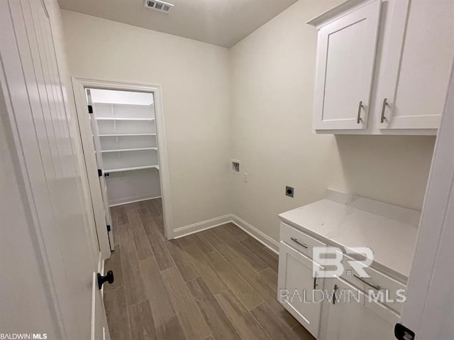 22258 Hibiscus Cir, Foley, AL 36535 - washroom featuring cabinet space, baseboards, hookup for an electric dryer, hookup for a washing machine, and wood tiled floor