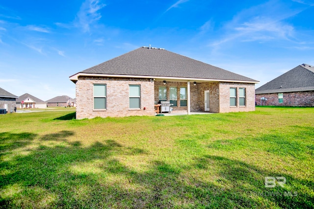 22258 Hibiscus Cir, Foley, AL 36535 - back of house with brick siding, a patio area, and a yard