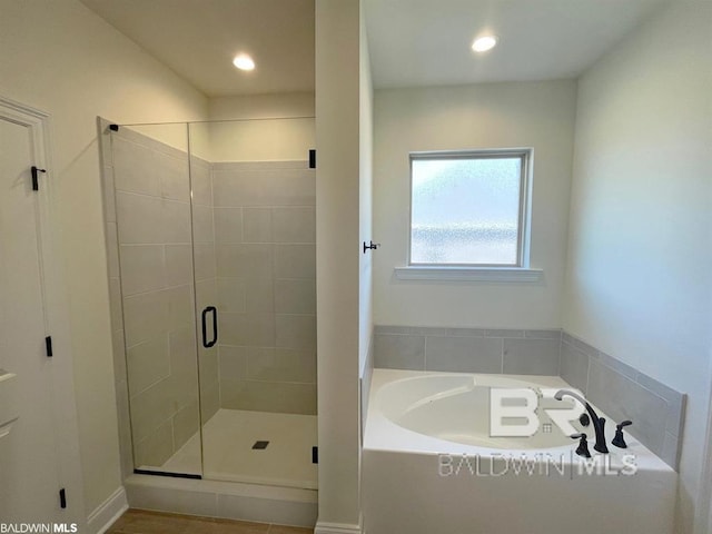 22258 Hibiscus Cir, Foley, AL 36535 - bathroom featuring a bath, recessed lighting, and a shower stall