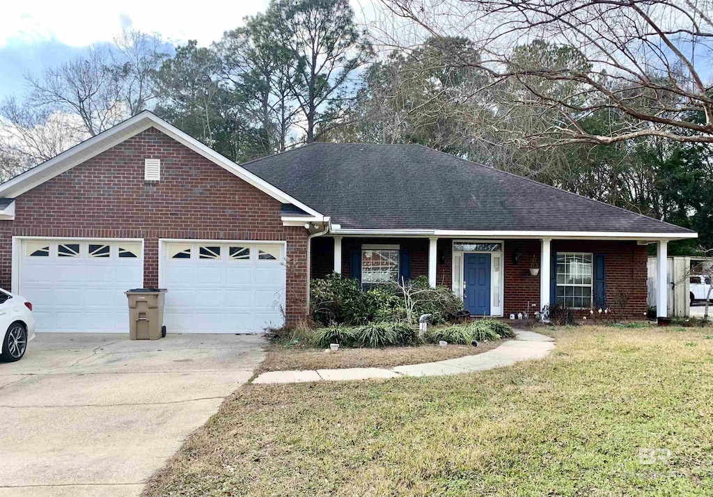 ranch-style home with a garage and a front lawn