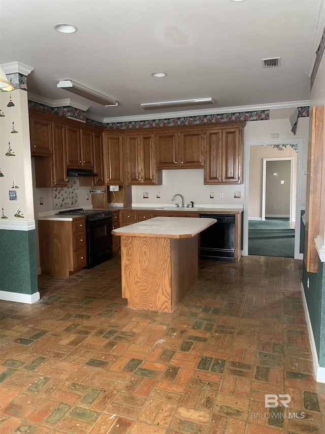 kitchen featuring ornamental molding, a center island, sink, and black appliances