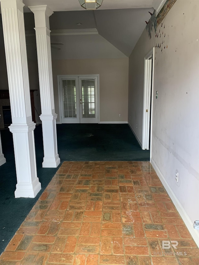 interior space with ornate columns, lofted ceiling, and french doors