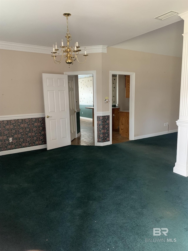 empty room featuring ornamental molding, a notable chandelier, and dark carpet