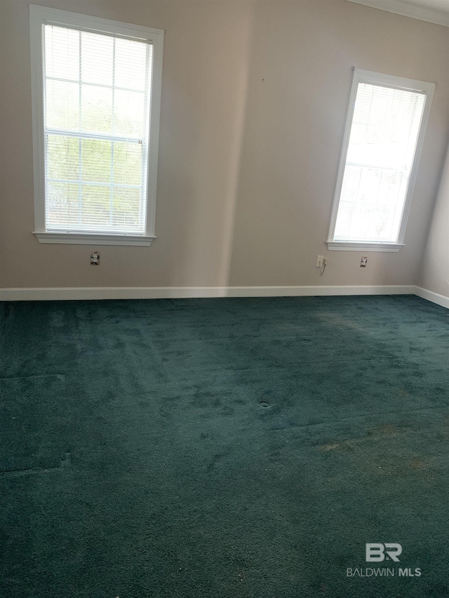 empty room with a healthy amount of sunlight and dark carpet