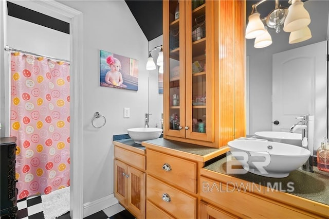 bathroom with vanity and vaulted ceiling