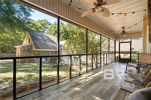 unfurnished sunroom with wooden ceiling and ceiling fan